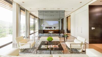 Modern living room with large windows and white furniture