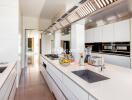 Modern kitchen with white cabinetry, stainless steel appliances, and a spacious island