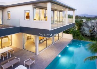 Modern two-story house with large windows and swimming pool