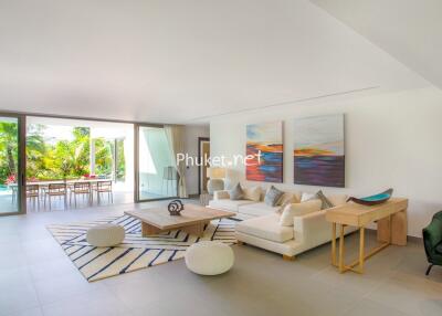 Spacious living room with modern furniture and pool view