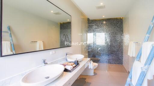 Modern bathroom with double sinks and glass shower