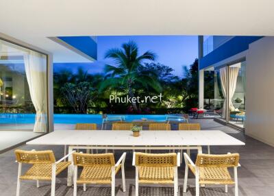 Indoor dining area overlooking outdoor swimming pool