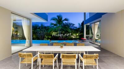 Indoor dining area overlooking outdoor swimming pool