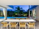 Indoor dining area overlooking outdoor swimming pool