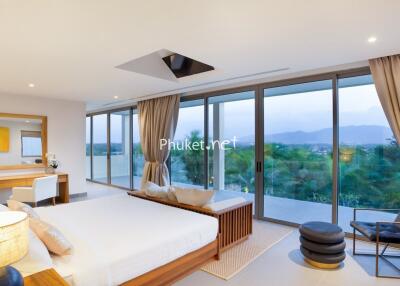 Spacious bedroom with large windows and a view