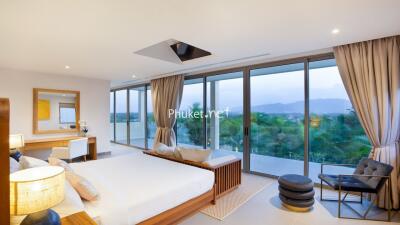 Spacious bedroom with large windows and a view