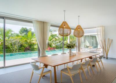 Spacious dining area with large windows and pool view