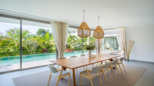 Spacious dining area with large windows and pool view