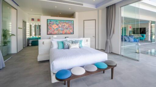 Modern bedroom with white décor and colorful art