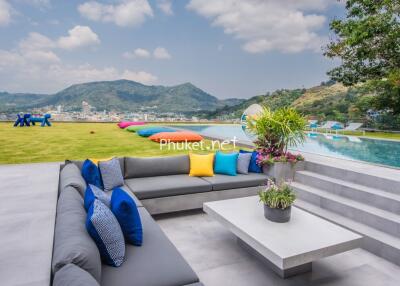Beautiful outdoor seating area with a view of the mountains and an infinity pool