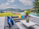 Beautiful outdoor seating area with a view of the mountains and an infinity pool