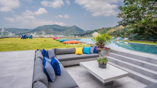 Beautiful outdoor seating area with a view of the mountains and an infinity pool