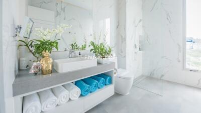 Modern bathroom with marble walls and plants