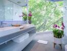 Modern bathroom with a large window view and orchids