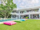 Exterior view of a modern villa with a swimming pool and garden