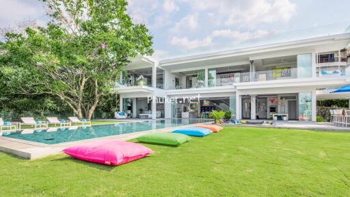 Exterior view of a modern villa with a swimming pool and garden