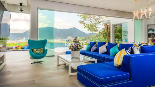 Modern living room with mountain view and blue furniture