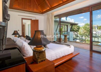 Luxury bedroom with large windows overlooking the marina.