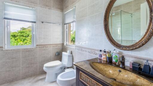 Modern bathroom with large mirror and a window view