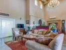 Spacious and well-decorated living room with high ceilings and chandelier