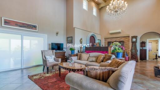 Spacious and well-decorated living room with high ceilings and chandelier