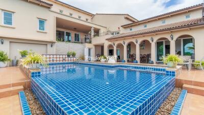 Exterior view of a luxurious house with a large swimming pool