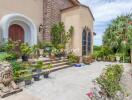 Front entrance of a house with a stone path, potted plants, and a lion statue