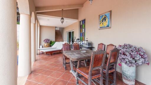 Outdoor patio with dining area and lounge chair