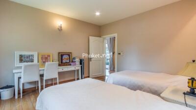 Bedroom with two beds and a study desk