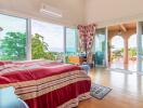 Spacious bedroom with ocean view and balcony access