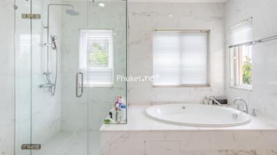 Spacious modern bathroom with bathtub and shower