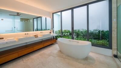 Modern bathroom with large window and freestanding bath