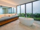 Modern bathroom with large window and freestanding bath