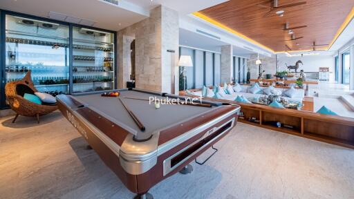 Spacious living area with pool table and large windows