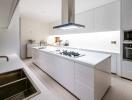 Modern kitchen with white cabinetry and appliances