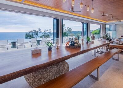 Spacious dining area with panoramic ocean view, modern fixtures, and open layout