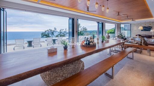 Spacious dining area with panoramic ocean view, modern fixtures, and open layout