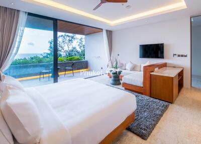 Spacious modern bedroom with balcony and ocean view