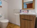 Modern bathroom with wooden vanity and toilet