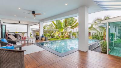 Covered patio area with pool and garden view