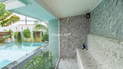 Outdoor pool area with a shower