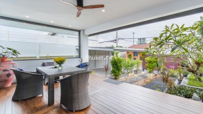 Covered terrace with outdoor dining area and garden view