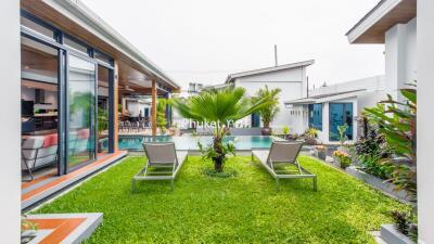 Modern outdoor area with pool and lounge chairs