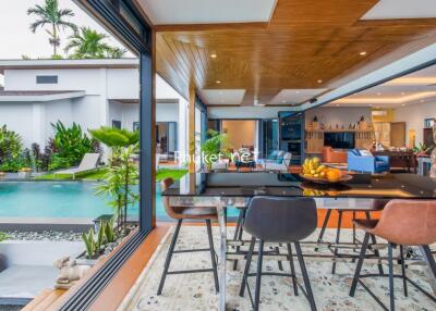 Open living area with dining space, pool view, and modern decor