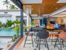 Open living area with dining space, pool view, and modern decor