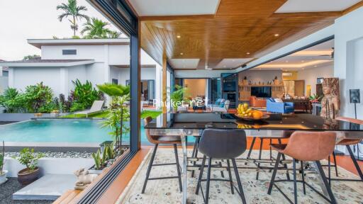 Open living area with dining space, pool view, and modern decor