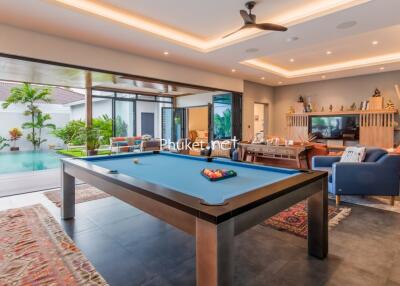 Modern living area with pool table and access to outdoor space