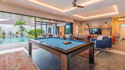 Modern living area with pool table and access to outdoor space