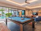 Modern living area with pool table and access to outdoor space