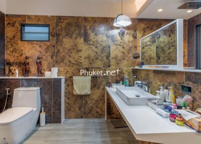 Modern bathroom with decorative wall tiles, sink and amenities